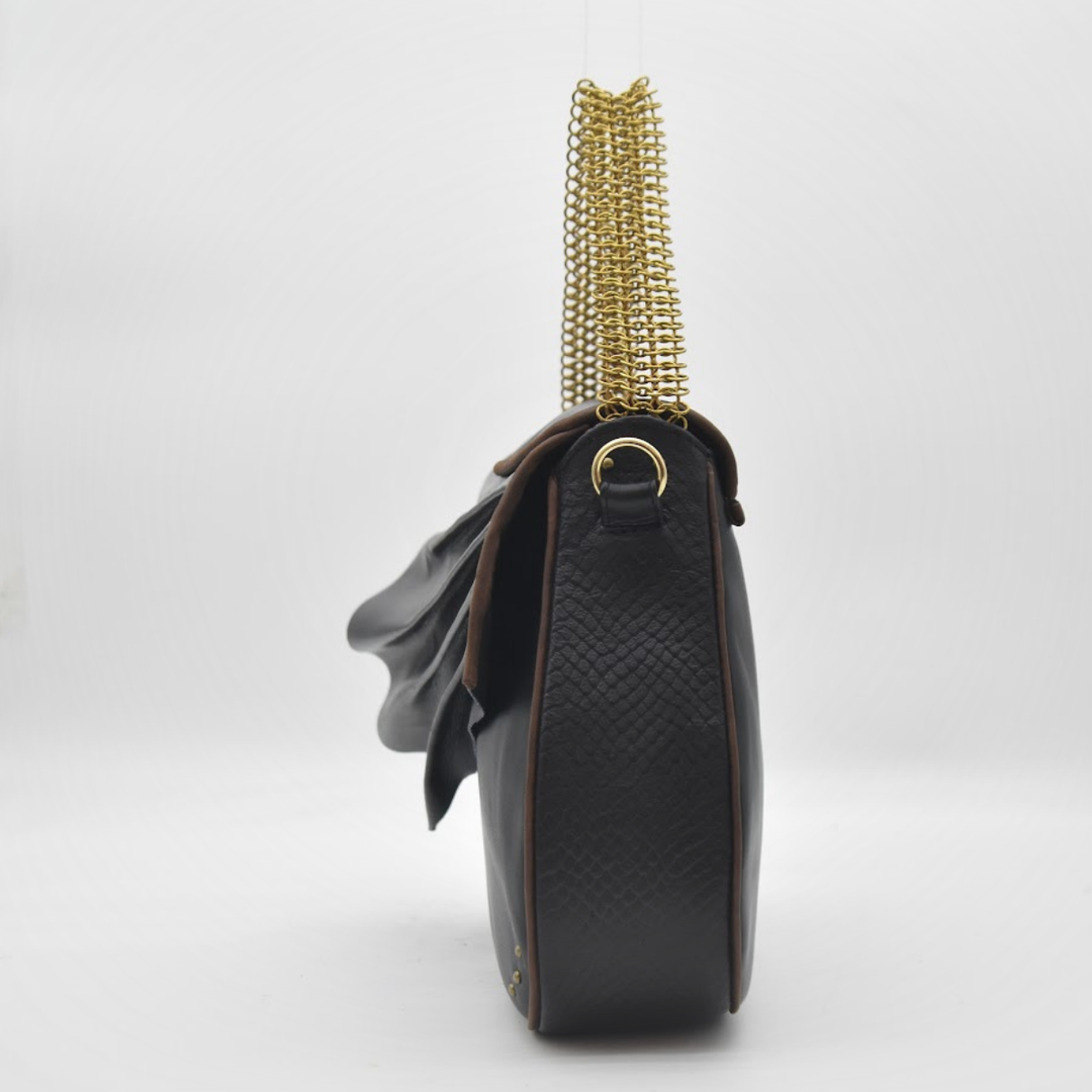 ISIS draped black leather wave and fine brass chain close-up