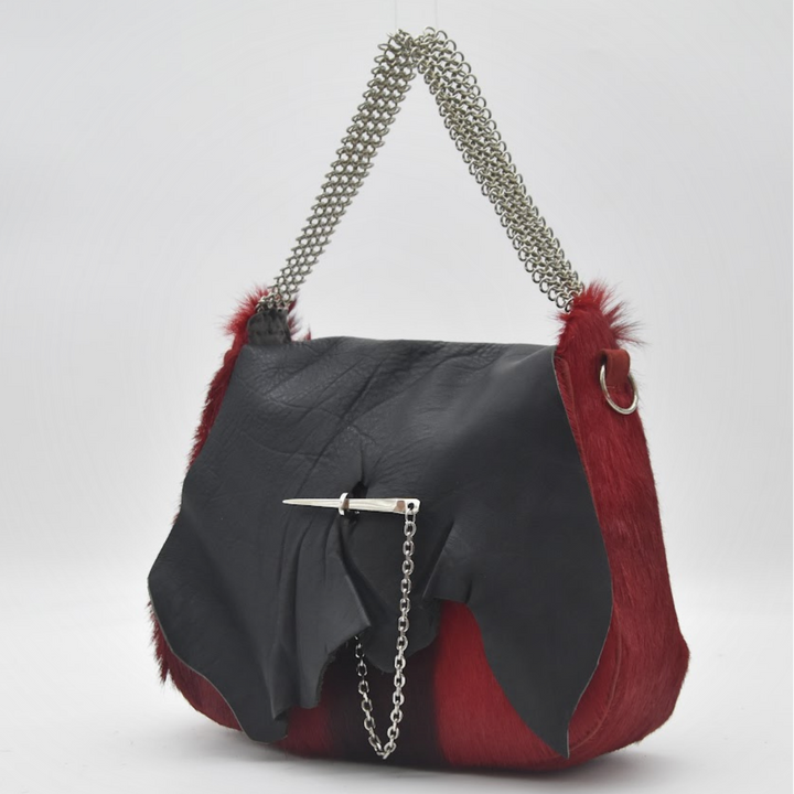 RED RUBY saddle bag in fire red African springbok and black leather with brass toggle in silver, front view, Patricia Bos Designs